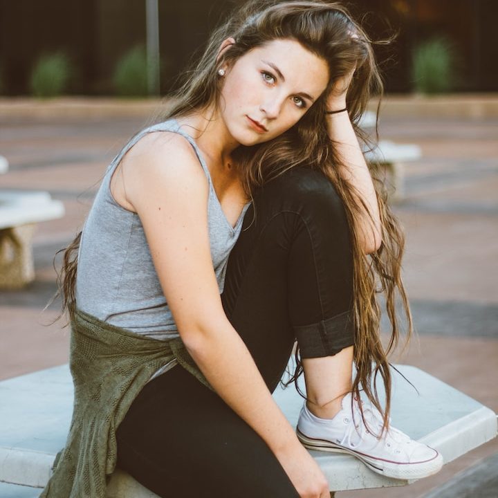 woman sitting on picnic table